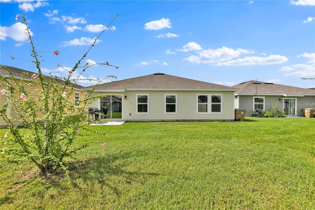 4492 Bluff Oak Loop, Kissimmee, FL 34746 - rear view of property featuring a lawn and a patio area