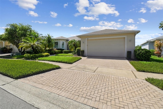 201 Largo Dr, Kissimmee, FL 34759 - ranch-style house featuring decorative driveway, stucco siding, an attached garage, and a front yard