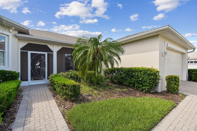 201 Largo Dr, Kissimmee, FL 34759 - view of front of home featuring an attached garage, stucco siding, and driveway