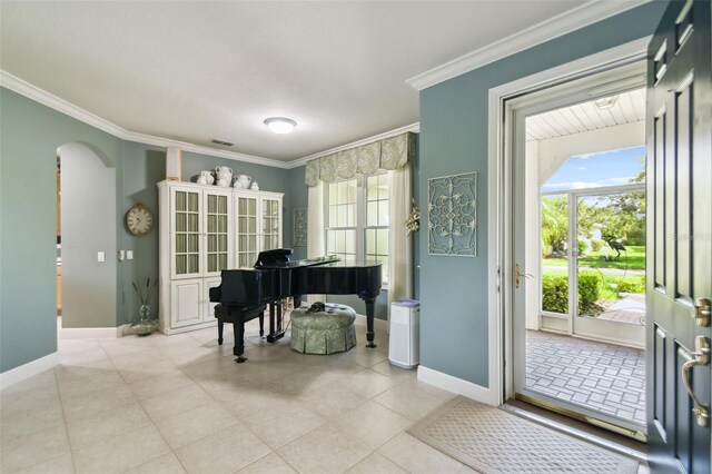 201 Largo Dr, Kissimmee, FL 34759 - foyer featuring ornamental molding, arched walkways, and light tile patterned floors