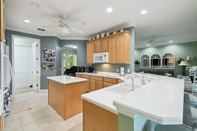 201 Largo Dr, Kissimmee, FL 34759 - kitchen featuring white appliances, ceiling fan, a center island, arched walkways, and a peninsula