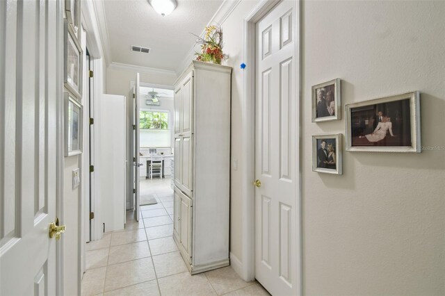201 Largo Dr, Kissimmee, FL 34759 - hallway featuring ornamental molding and light tile patterned floors