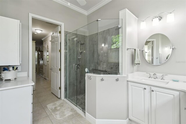 201 Largo Dr, Kissimmee, FL 34759 - full bath with crown molding, a stall shower, tile patterned floors, and vanity