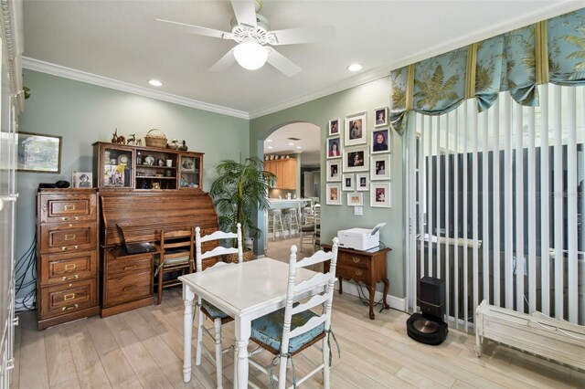 201 Largo Dr, Kissimmee, FL 34759 - dining area featuring arched walkways, light wood finished floors, ornamental molding, ceiling fan, and recessed lighting