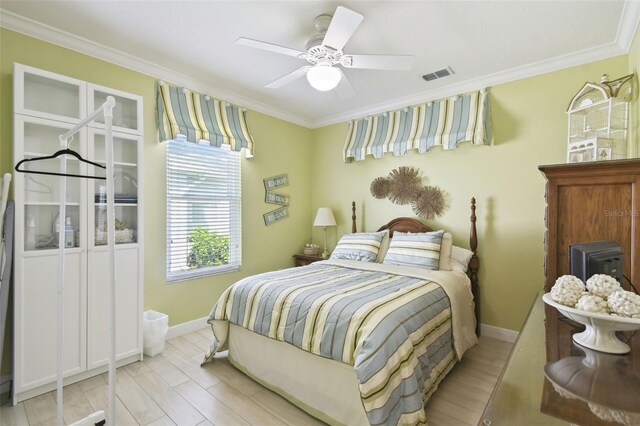 201 Largo Dr, Kissimmee, FL 34759 - bedroom featuring crown molding, ceiling fan, and light wood finished floors
