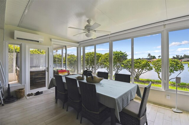 201 Largo Dr, Kissimmee, FL 34759 - sunroom / solarium with a wall unit AC, wood finished floors, and a deck with water view