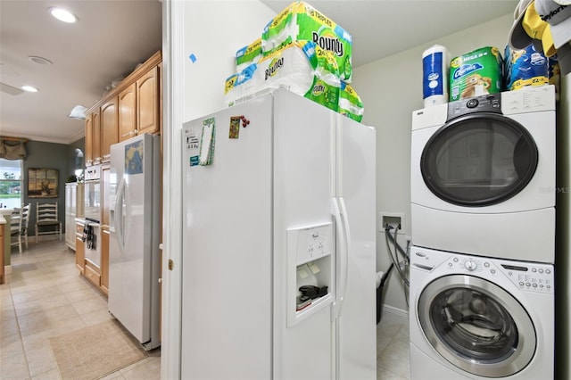 201 Largo Dr, Kissimmee, FL 34759 - laundry area featuring estacked washer and dryer, light tile patterned floors, recessed lighting, and crown molding