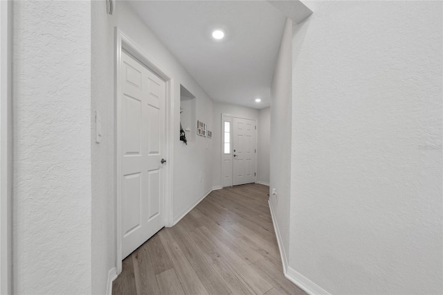 1719 Daystar Dr, Haines City, FL 33844 - hall featuring a textured wall, light wood-style flooring, and recessed lighting