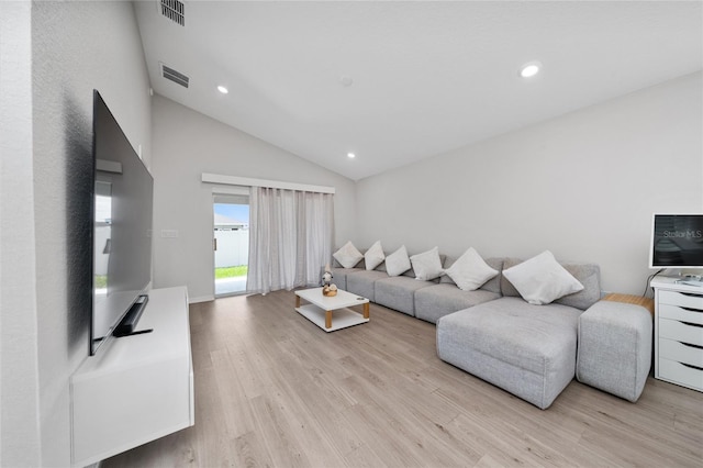 1719 Daystar Dr, Haines City, FL 33844 - living area featuring light wood-style flooring, recessed lighting, and high vaulted ceiling