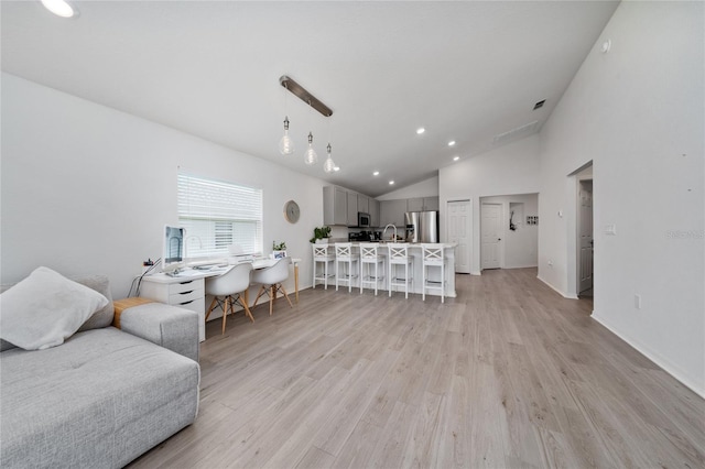 1719 Daystar Dr, Haines City, FL 33844 - living area with vaulted ceiling, light wood-style flooring, and recessed lighting