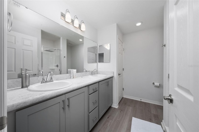 1719 Daystar Dr, Haines City, FL 33844 - full bathroom with double vanity, wood finished floors, an enclosed shower, and recessed lighting