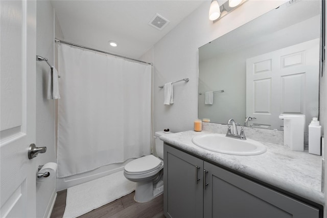 1719 Daystar Dr, Haines City, FL 33844 - full bathroom featuring vanity, wood finished floors, and shower / tub combo