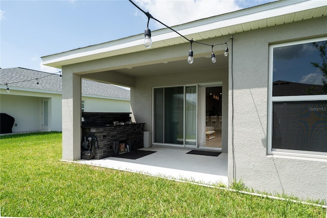 1719 Daystar Dr, Haines City, FL 33844 - back of house featuring stucco siding, a lawn, and a patio