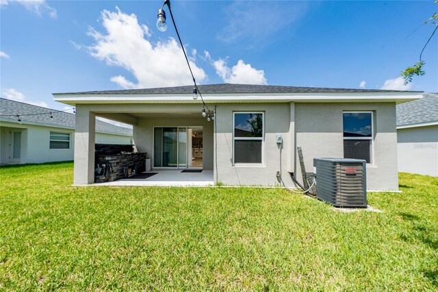 1719 Daystar Dr, Haines City, FL 33844 - rear view of property with stucco siding, a patio area, a lawn, and area for grilling