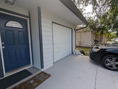 946 Delano Ct, Kissimmee, FL 34758 - entrance to property with a garage and concrete driveway