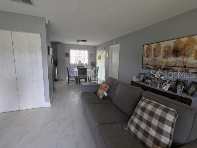 946 Delano Ct, Kissimmee, FL 34758 - living room featuring marble look tile flooring