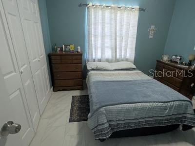 946 Delano Ct, Kissimmee, FL 34758 - bedroom featuring a closet and marble look tile flooring