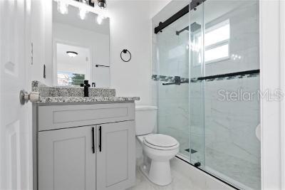 946 Delano Ct, Kissimmee, FL 34758 - bathroom featuring toilet, vanity, a shower stall, and healthy amount of natural light