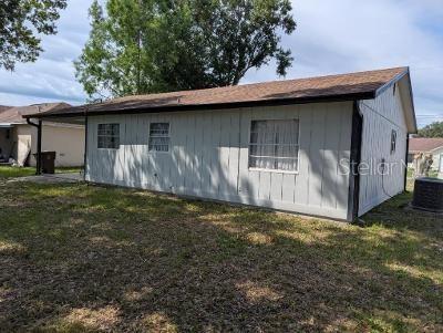 946 Delano Ct, Kissimmee, FL 34758 - view of property exterior featuring a yard and cooling unit
