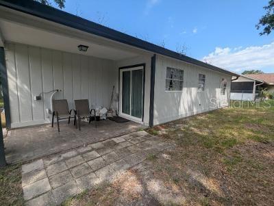 946 Delano Ct, Kissimmee, FL 34758 - back of property with a patio and board and batten siding