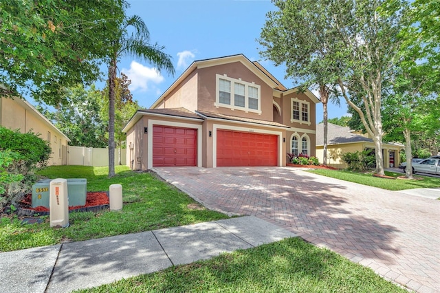 6932 Gray Catbird Loop, Wesley Chapel, FL 33545 - traditional home featuring stucco siding, a garage, and decorative driveway
