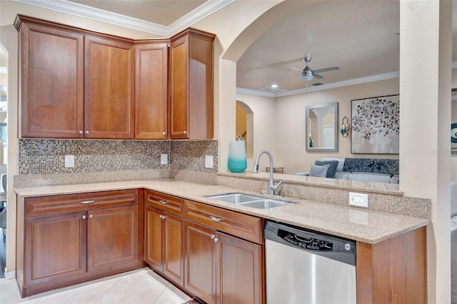 6932 Gray Catbird Loop, Wesley Chapel, FL 33545 - kitchen with stainless steel dishwasher, arched walkways, a ceiling fan, ornamental molding, and light stone countertops