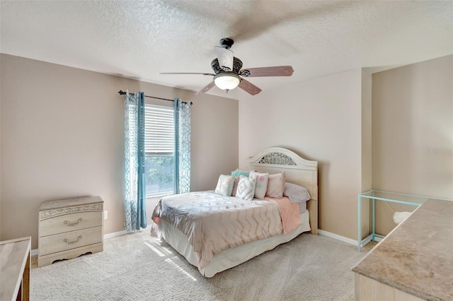 6932 Gray Catbird Loop, Wesley Chapel, FL 33545 - bedroom with light colored carpet, a textured ceiling, and a ceiling fan