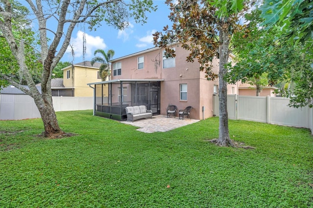 6932 Gray Catbird Loop, Wesley Chapel, FL 33545 - back of house featuring a sunroom, stucco siding, a fenced backyard, and a patio