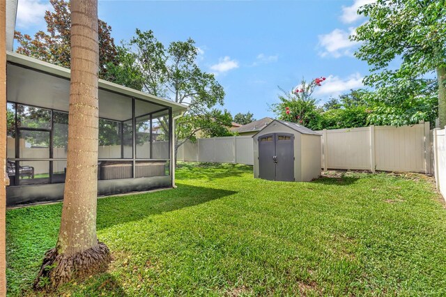 6932 Gray Catbird Loop, Wesley Chapel, FL 33545 - fenced backyard with a storage unit and a sunroom