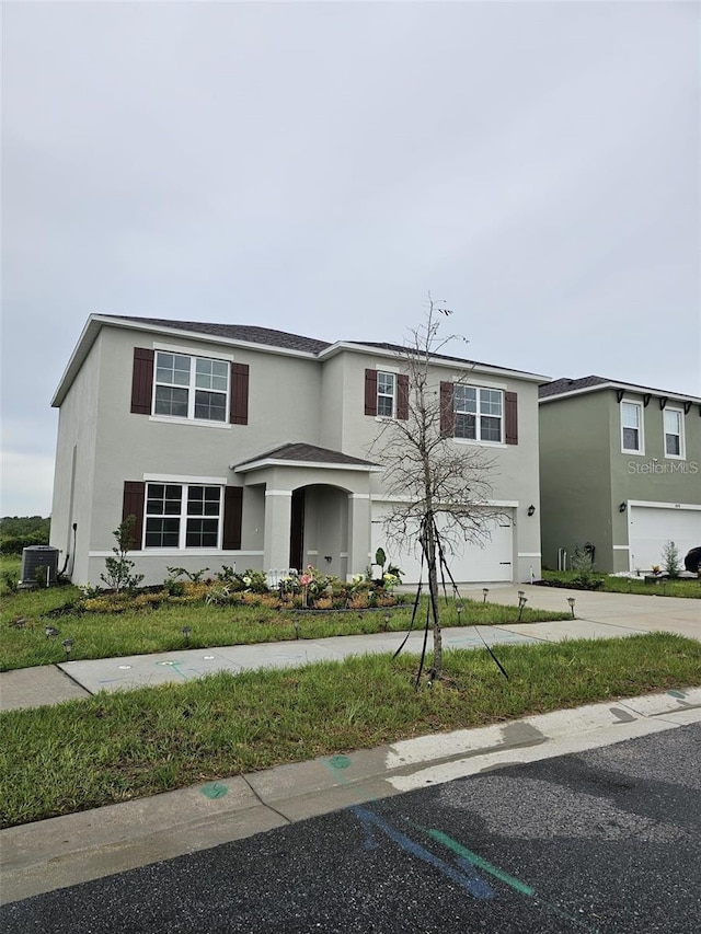 3886 Whitney Way, Haines City, FL 33844 - traditional-style home with stucco siding, an attached garage, driveway, and a front yard