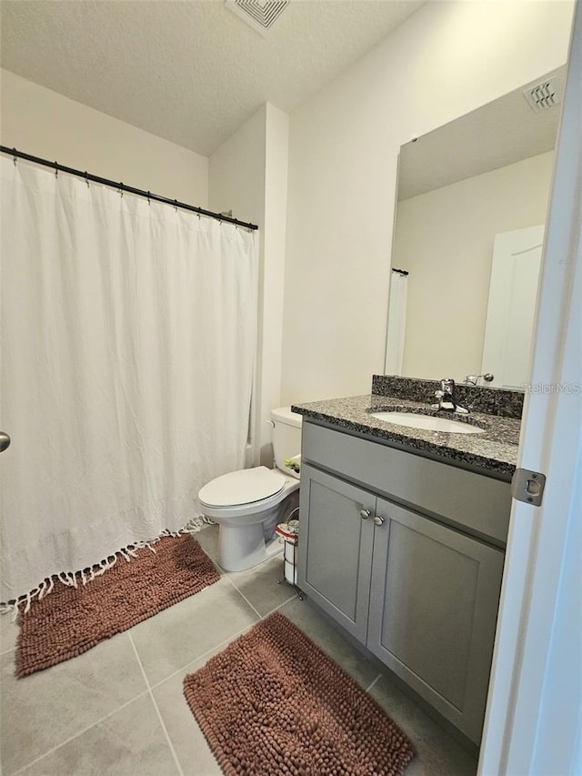 3886 Whitney Way, Haines City, FL 33844 - bathroom featuring toilet, vanity, tile patterned flooring, a textured ceiling, and a shower with shower curtain