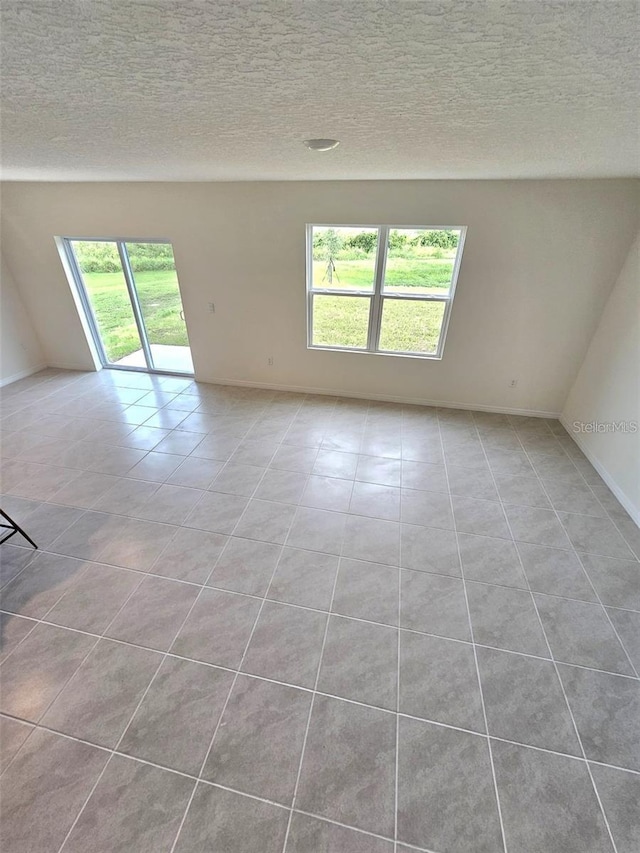3886 Whitney Way, Haines City, FL 33844 - unfurnished room featuring light tile patterned floors and a textured ceiling