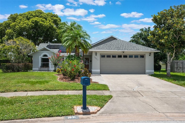 1631 Woodbay Ct, Kissimmee, FL 34744 - single story home featuring a garage, a front lawn, driveway, and stucco siding