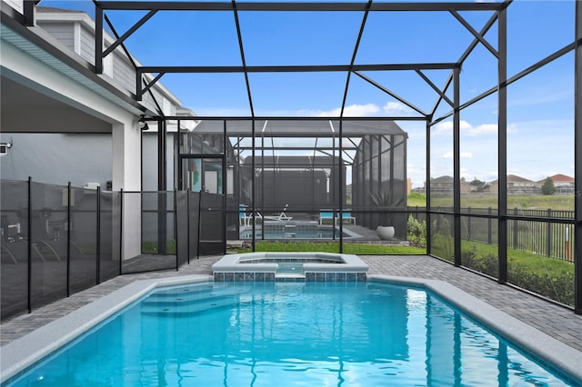 2176 Lelani Cir, Davenport, FL 33897 - view of swimming pool featuring a patio, a pool with connected hot tub, and glass enclosure
