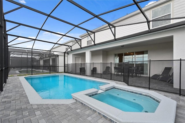 2176 Lelani Cir, Davenport, FL 33897 - view of swimming pool featuring a patio area, a pool with connected hot tub, and glass enclosure