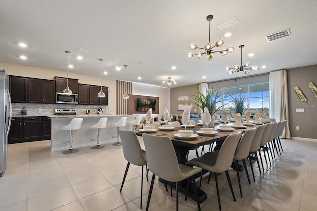 2176 Lelani Cir, Davenport, FL 33897 - dining room featuring a chandelier, light tile patterned floors, recessed lighting, and baseboards