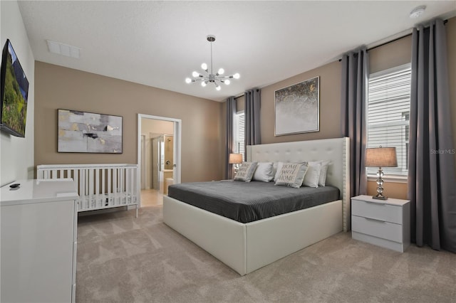 2176 Lelani Cir, Davenport, FL 33897 - bedroom featuring light carpet, a chandelier, and ensuite bath