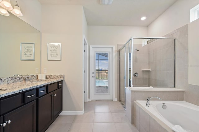 2176 Lelani Cir, Davenport, FL 33897 - full bathroom with vanity, a garden tub, a stall shower, tile patterned flooring, and baseboards