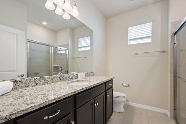 2176 Lelani Cir, Davenport, FL 33897 - bathroom featuring vanity, toilet, a tile shower, tile patterned flooring, and baseboards