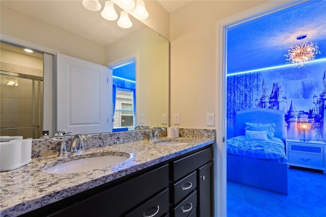 2176 Lelani Cir, Davenport, FL 33897 - bathroom with double vanity, a chandelier, and a shower with door
