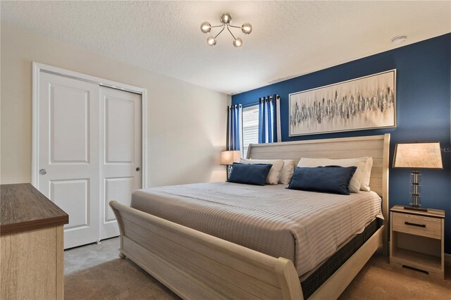 2176 Lelani Cir, Davenport, FL 33897 - bedroom featuring carpet flooring, a closet, and a textured ceiling