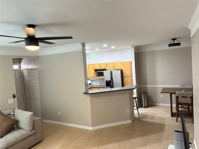 3301 Soho St Unit 104, Orlando, FL 32835 - kitchen with stainless steel appliances, crown molding, light tile patterned floors, recessed lighting, and a ceiling fan