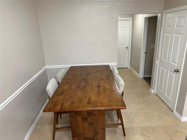 3301 Soho St Unit 104, Orlando, FL 32835 - unfurnished dining area featuring light tile patterned floors and baseboards