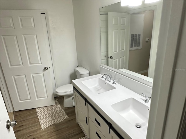 3301 Soho St Unit 104, Orlando, FL 32835 - bathroom with wood finished floors, double vanity, and toilet