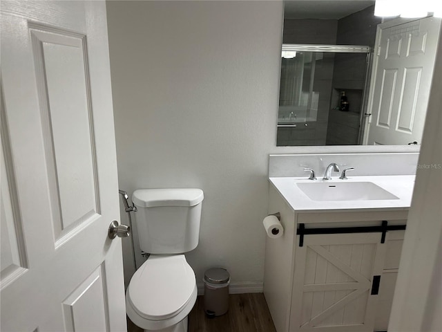 3301 Soho St Unit 104, Orlando, FL 32835 - full bath with wood finished floors, toilet, vanity, a stall shower, and baseboards