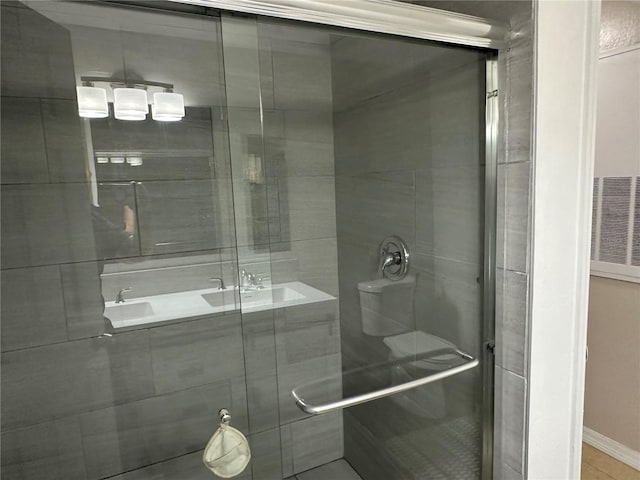 3301 Soho St Unit 104, Orlando, FL 32835 - bathroom featuring a shower stall, baseboards, and tile patterned flooring