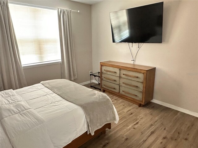 3301 Soho St Unit 104, Orlando, FL 32835 - bedroom featuring light wood-type flooring and baseboards