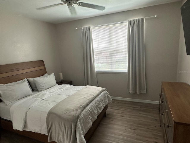 3301 Soho St Unit 104, Orlando, FL 32835 - bedroom featuring wood finished floors, baseboards, and a ceiling fan