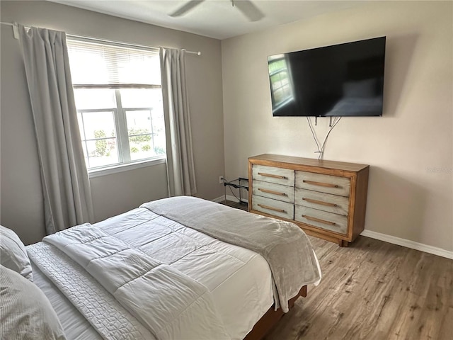 3301 Soho St Unit 104, Orlando, FL 32835 - bedroom with baseboards, light wood-style flooring, and ceiling fan