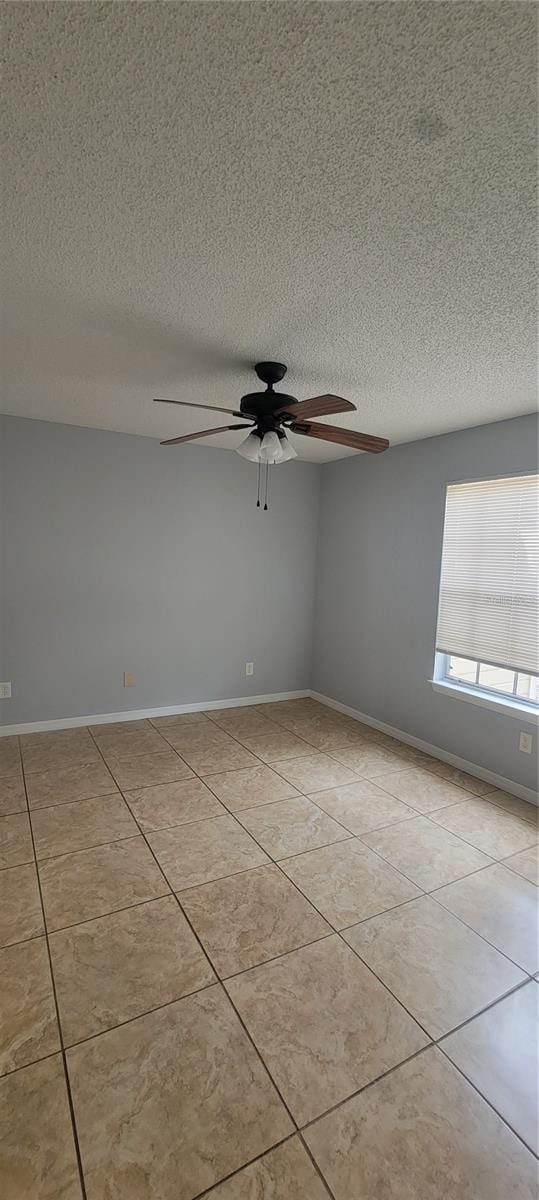 1023 S Hiawassee Rd Unit 4017, Orlando, FL 32835 - tiled empty room featuring ceiling fan, a textured ceiling, and baseboards